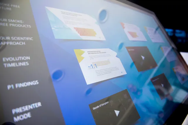Close-up of a digital touchscreen displaying interface panels and data