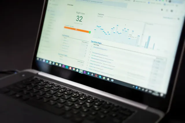 Laptop displaying an analytics dashboard with charts and trend lines