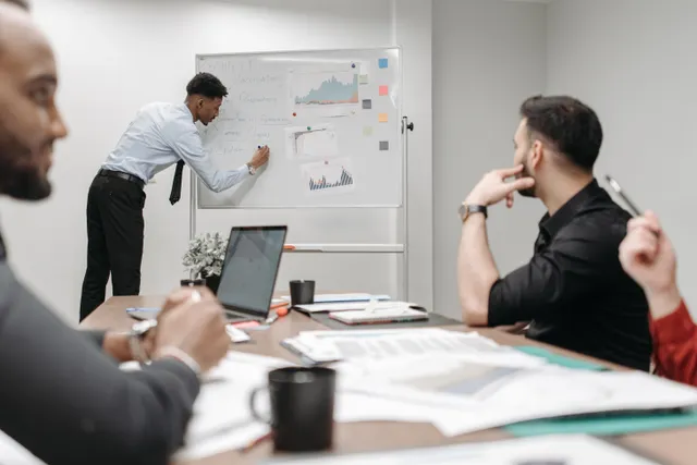 Colleagues reviewing data and strategy notes together in a meeting