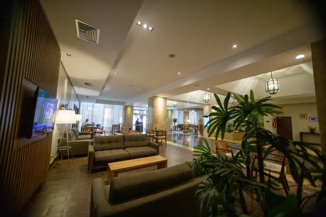 Spacious hotel lobby with modern furniture and warm lighting